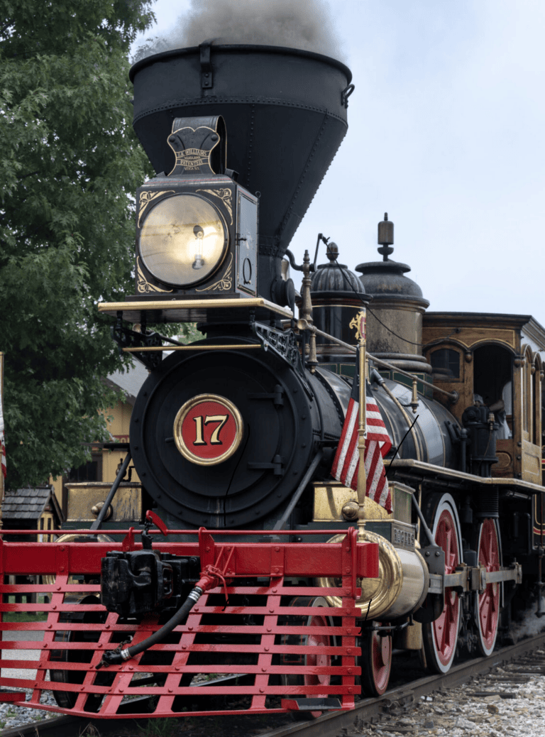 Steam locomotive engine 17 at a festival with red fencing and flags.