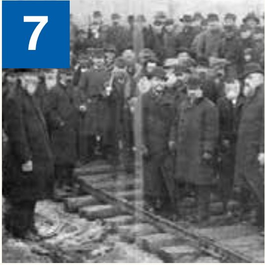 Historic photo of a crowd gathered at the railroad